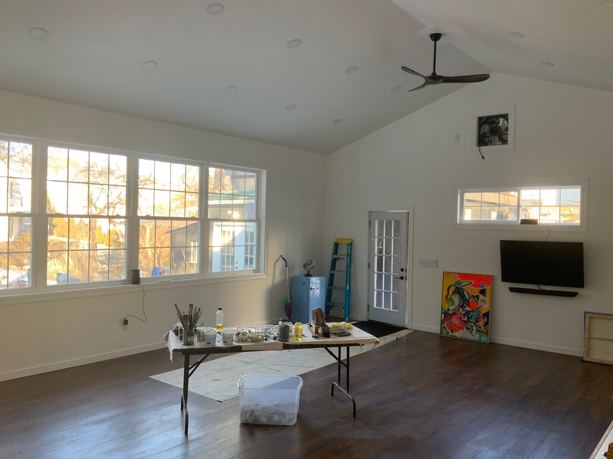 A private art studio with a vaulted ceiling and a long bank of windows.